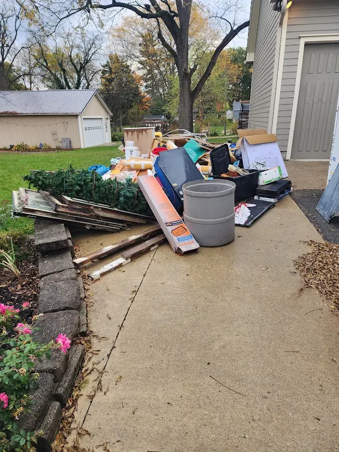 Dumpster being loaded with debris for 3 Yard Dumpster Rental in Allen Park